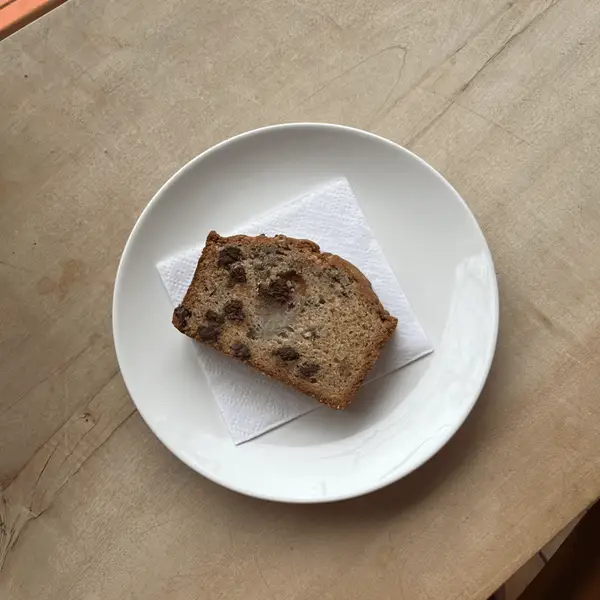 A slice of banana chocolate chip loaf on a plate