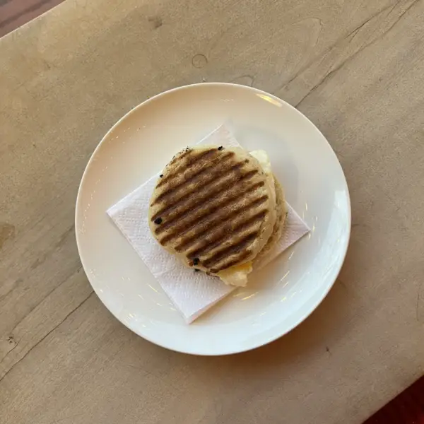 A pressed breakfast sandwich on an English muffin