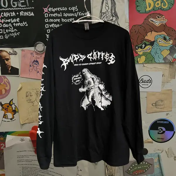 A black long-sleeve Bud's Coffee shirt with a Godzilla print