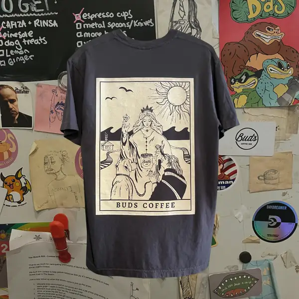 A charcoal T-shirt with a tarot-card style Bud's Coffee print