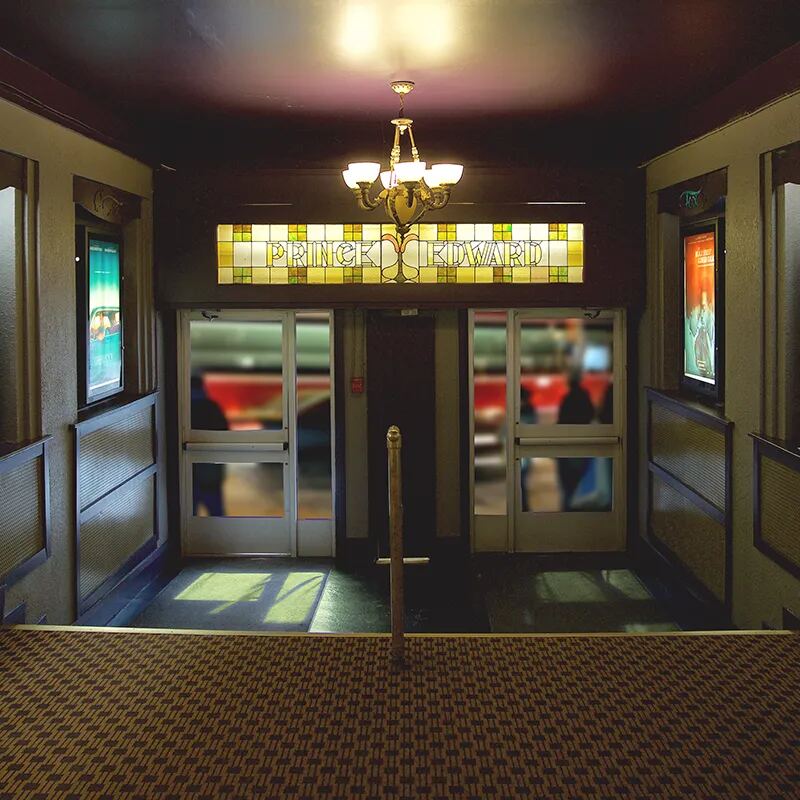 The Fox’s front doors under a stained glass transom and chandelier