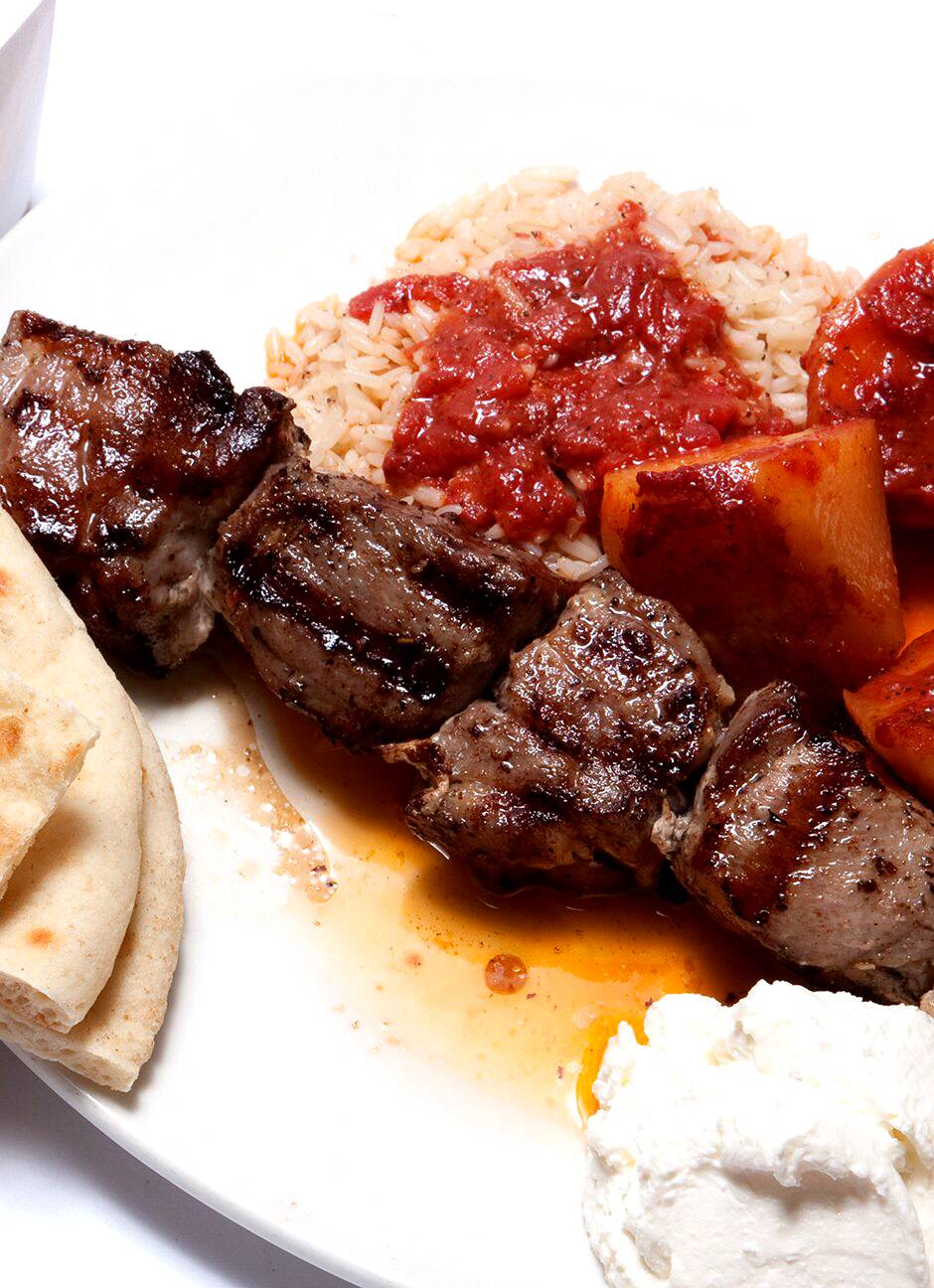Grilled lamb souvlaki with rice, potatoes, pita and tzatziki